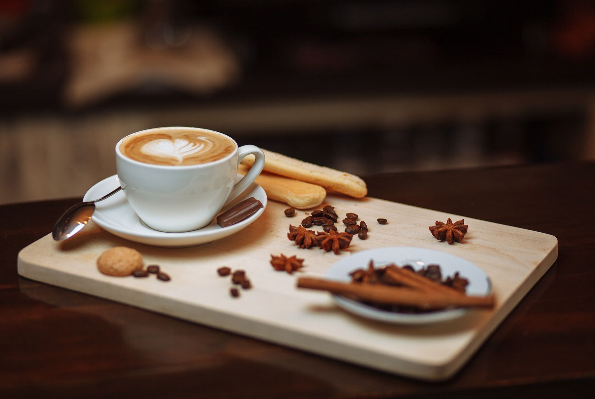 latte on a serving board with various spices spread on the board