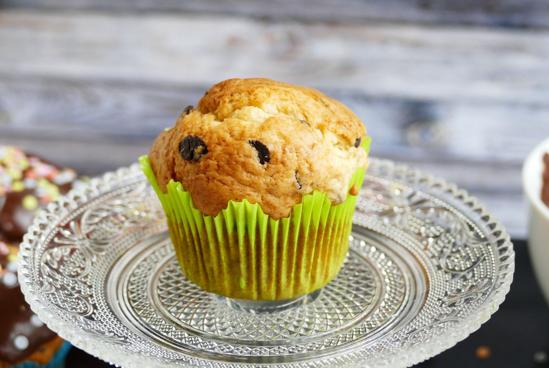 Close up blueberry muffin on a glass plate on a wooden table